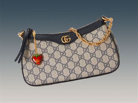 gucci purse with strawberry charm|Gucci ophidia bag.